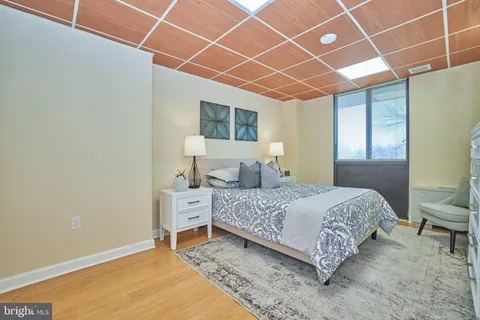 a bedroom with a bed and a chair