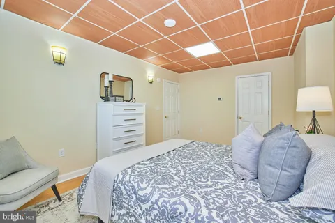 a bedroom with a bed and a chair