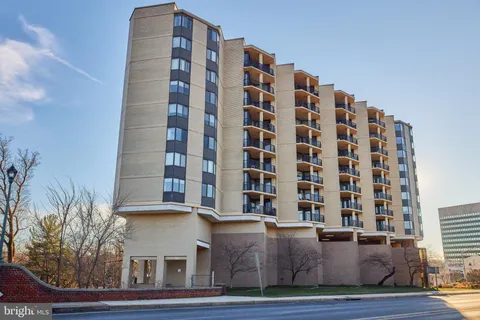 a view of tall building with a yard