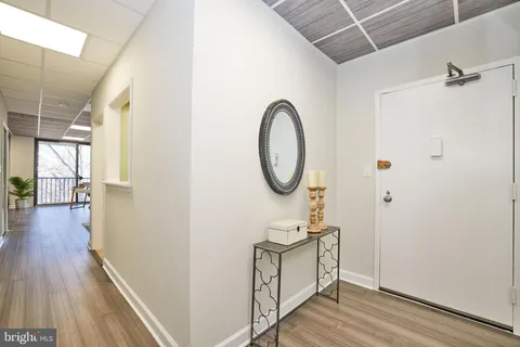 a view of a hallway with wooden floor