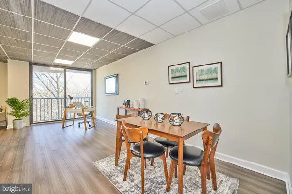 a dining room with furniture and wooden floor