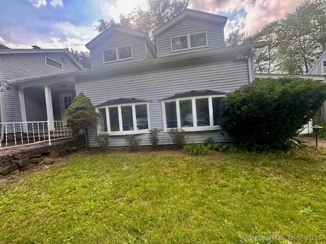 a backyard of a house with yard table and chairs