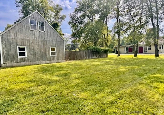 a house view with swimming pool in front of it