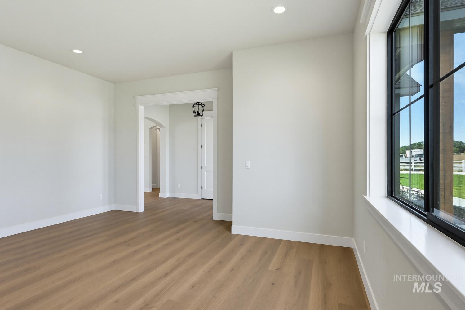 5054 Heritage Drive Marsing, ID 83639 - Photo 17 of 38 Open interior space featuring wood-finish flooring, recessed lighting, and a large window with black grilles
