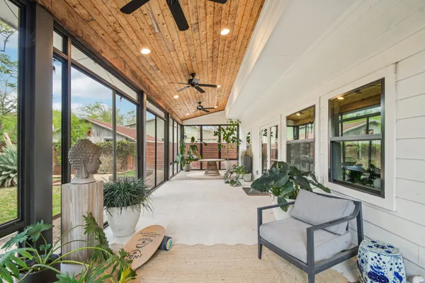 a lobby with furniture and potted plants