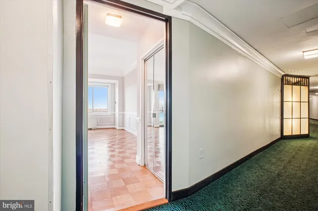 a view of a hallway with a livingroom and a hallway