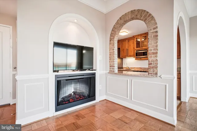a view of an empty room with window and cabinet