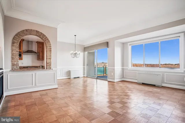 a view of a kitchen with a sink a refrigerator and wooden floor