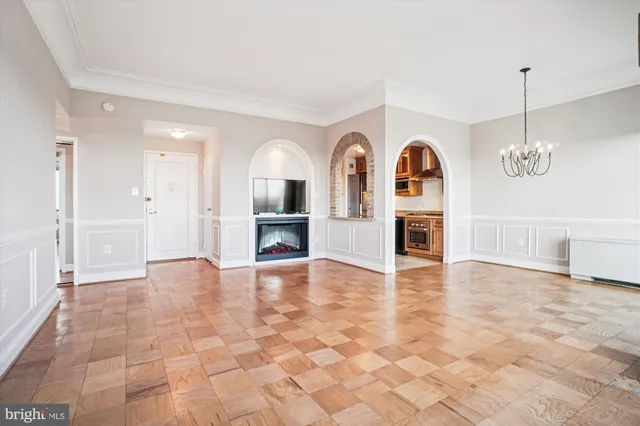 a view of an empty room with window and cabinet