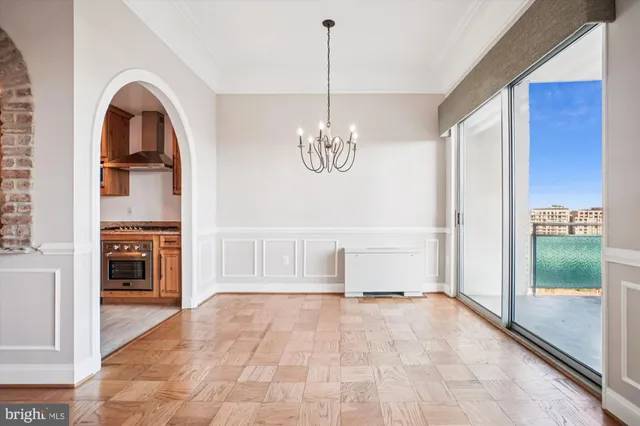 a view of spacious bathroom with a tub and chandelier