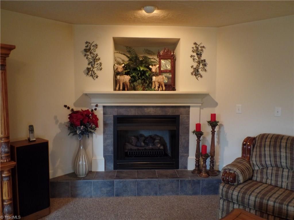 1022 Dulin Road Mocksville, NC 27028 - Photo 6 of 16 Beautiful fireplace with gas logs. An additional brick fireplace is located in the unfinished basement.