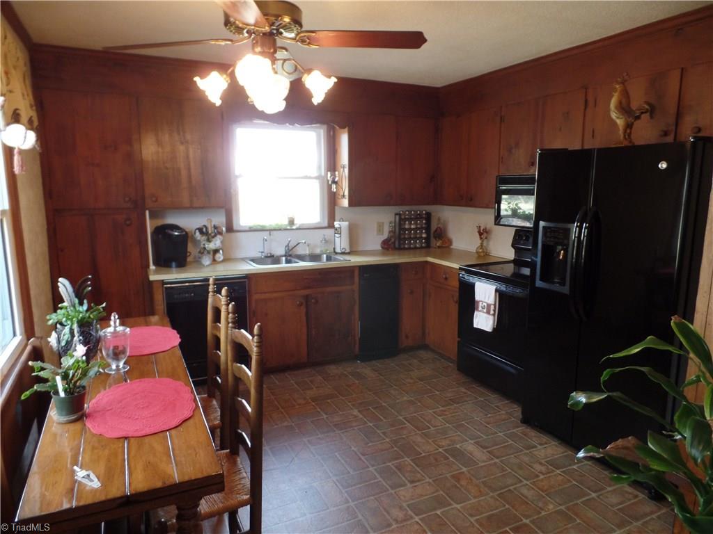 1022 Dulin Road Mocksville, NC 27028 - Photo 7 of 16 A country kitchen looks out onto the private backyard.