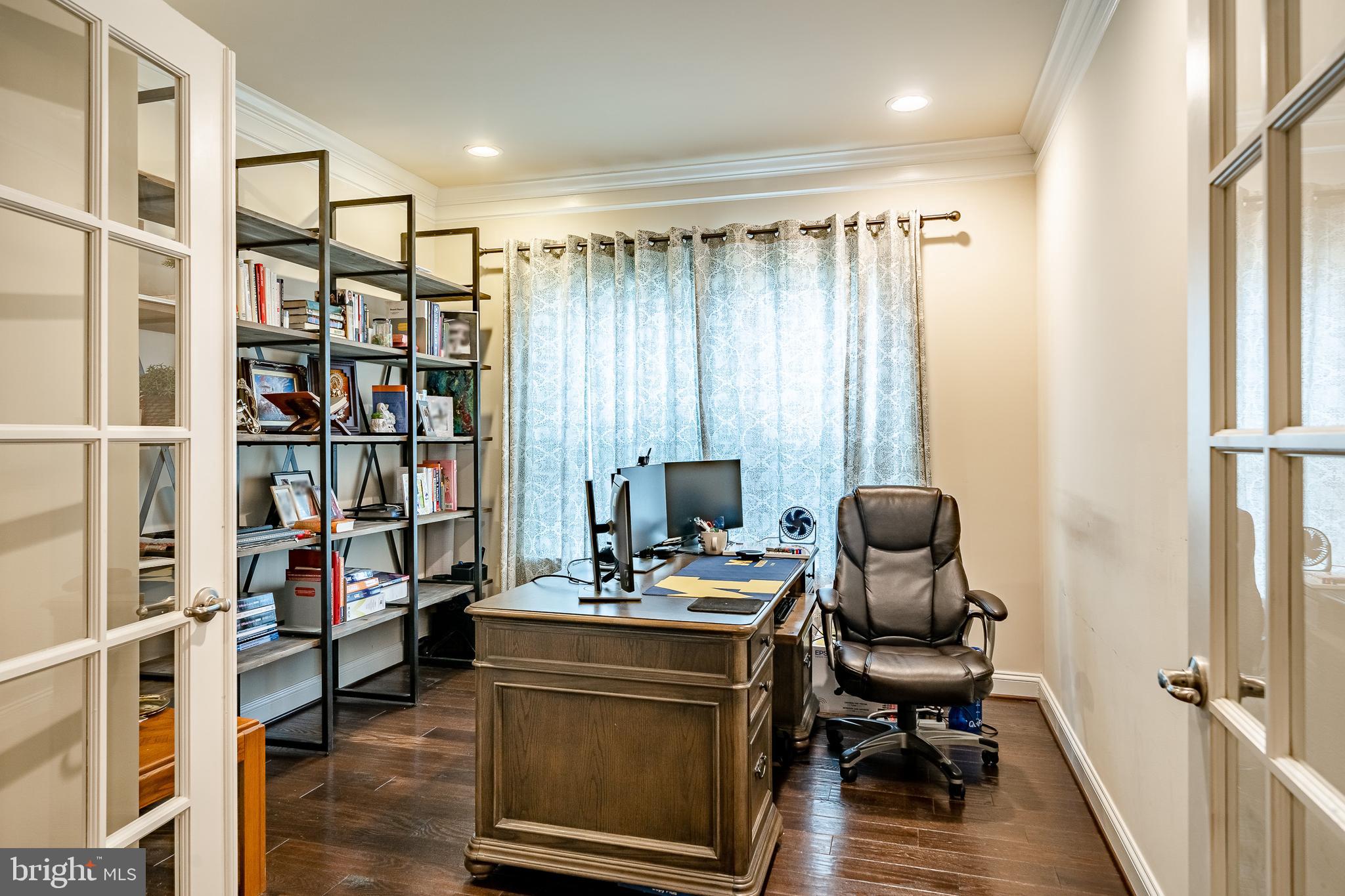 422 Quarry Point Road Malvern, PA 19355 - Photo 19 of 46 a view of a workspace with furniture and a book shelf