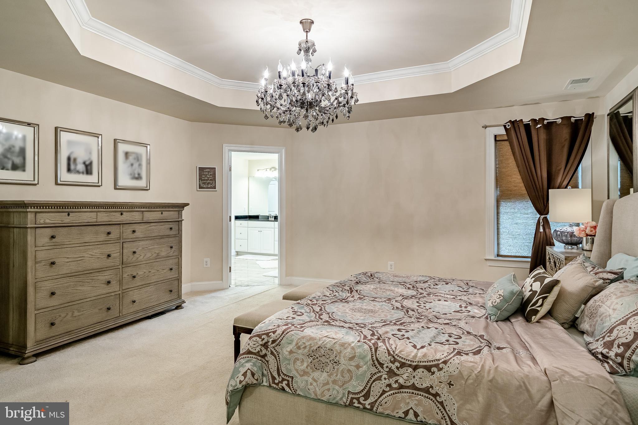 422 Quarry Point Road Malvern, PA 19355 - Photo 29 of 46 a bedroom with a large bed and a chandelier