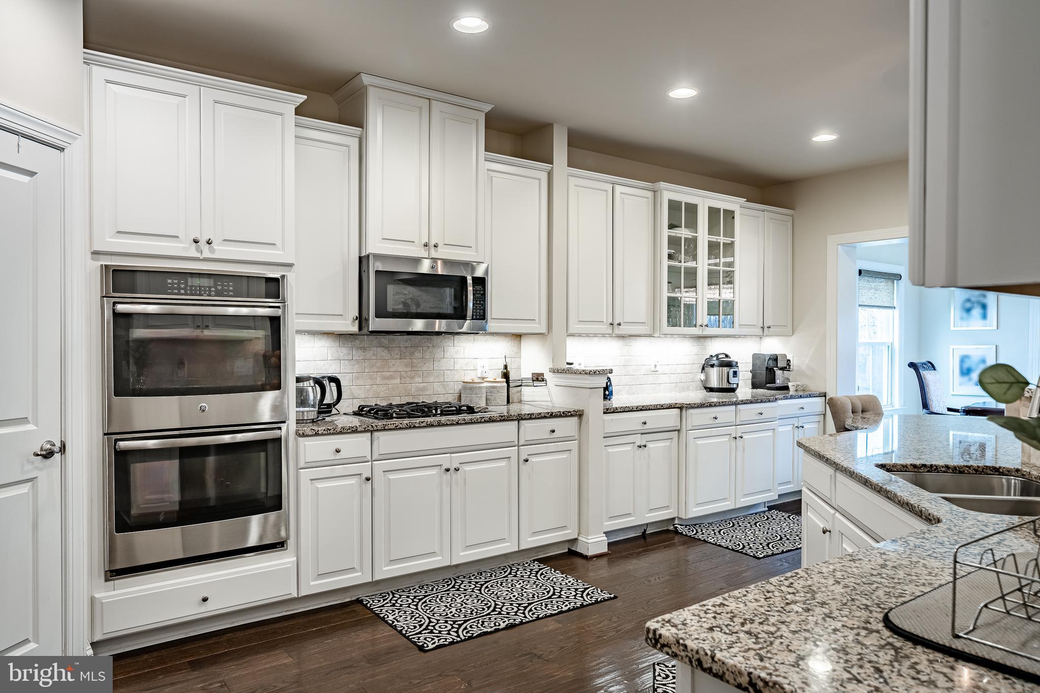 422 Quarry Point Road Malvern, PA 19355 - Photo 7 of 46 a kitchen with stainless steel appliances granite countertop a stove a sink and a microwave