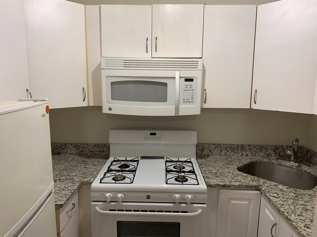 120 Bradlee Street, Unit 2 Boston, MA 02136 - Photo 2 of 12 a stove top oven sitting inside of a kitchen