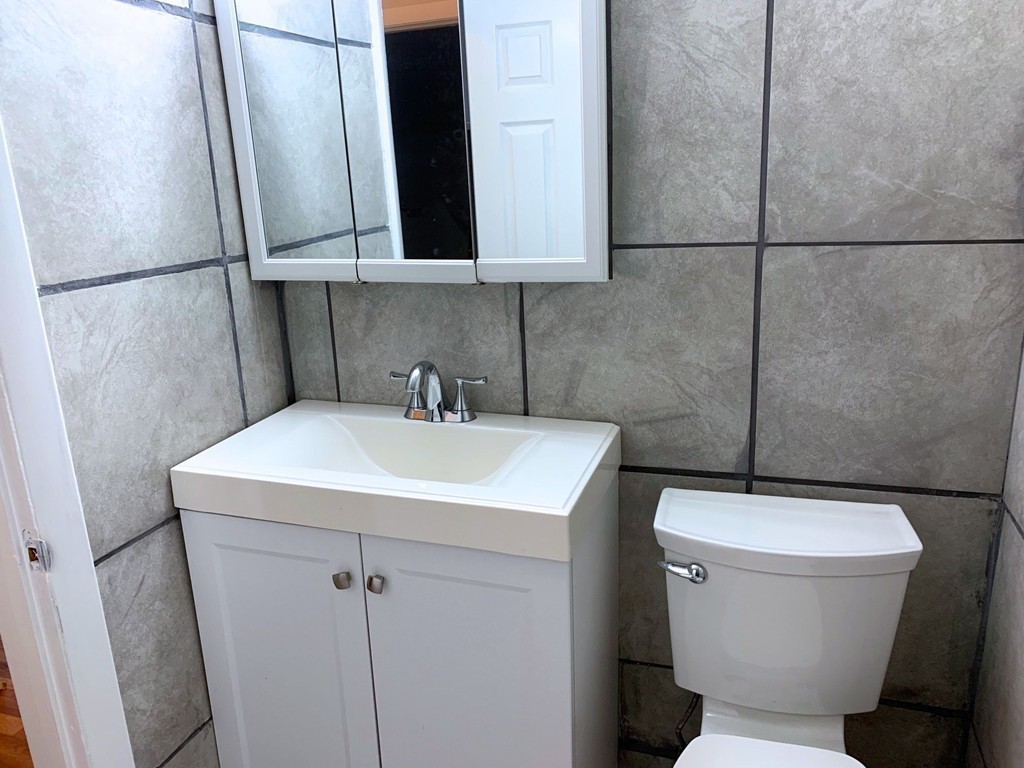 120 Bradlee Street, Unit 2 Boston, MA 02136 - Photo 4 of 12 a bathroom with a sink a toilet and a mirror