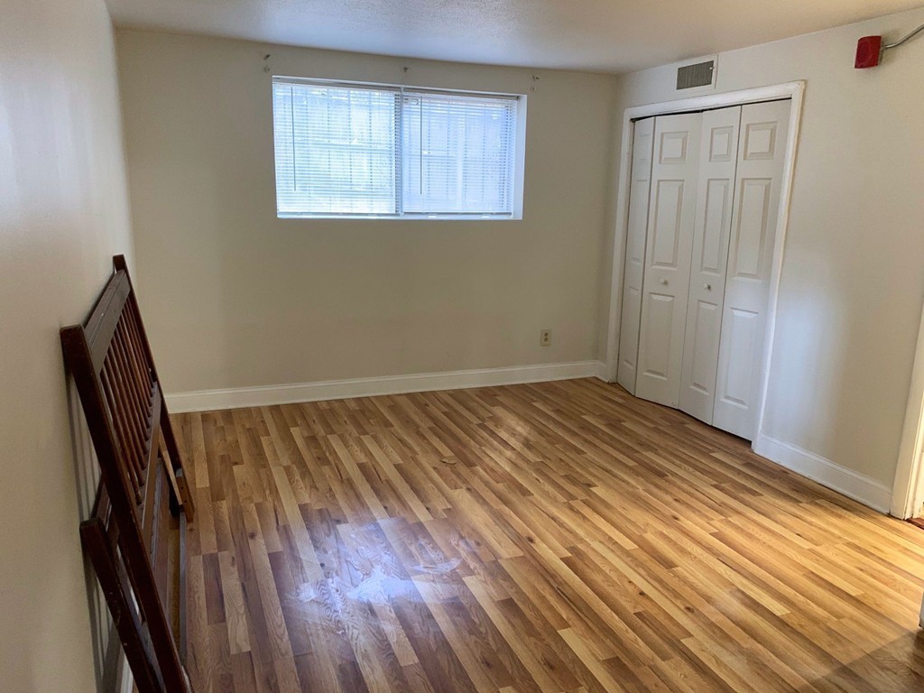 120 Bradlee Street, Unit 2 Boston, MA 02136 - Photo 9 of 12 a view of an empty room with wooden floor and a window