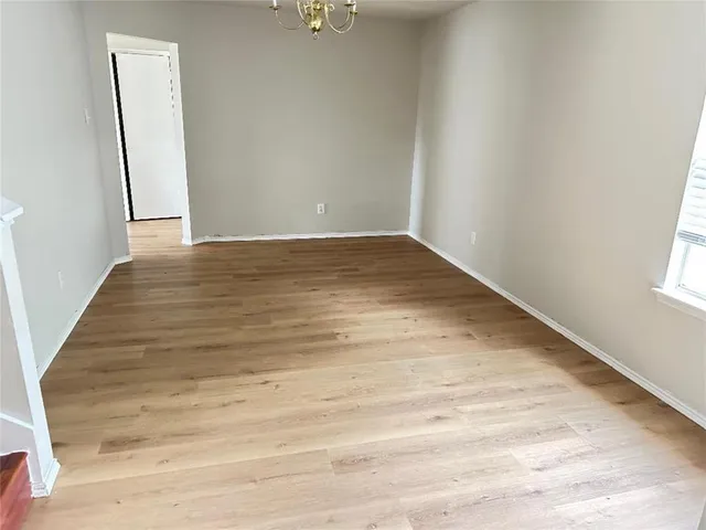 a view of a room with wooden floor