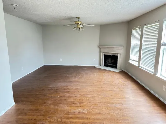 wooden floor in an empty room with a fireplace