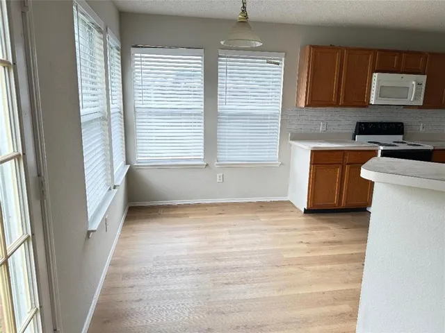 a view of a kitchen with an empty space and a window