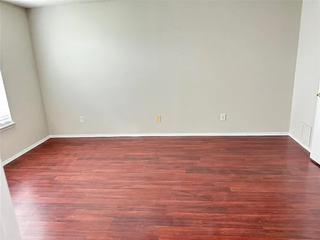 a view of room with wooden floor