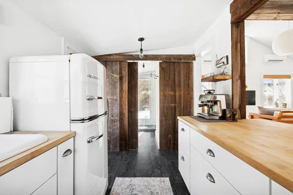 a kitchen with a refrigerator a sink and cabinets