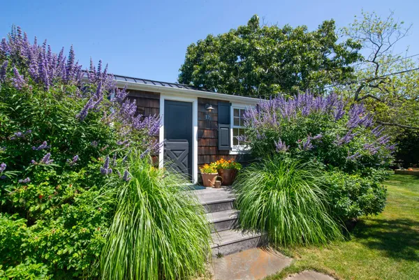 a front view of a house with a garden