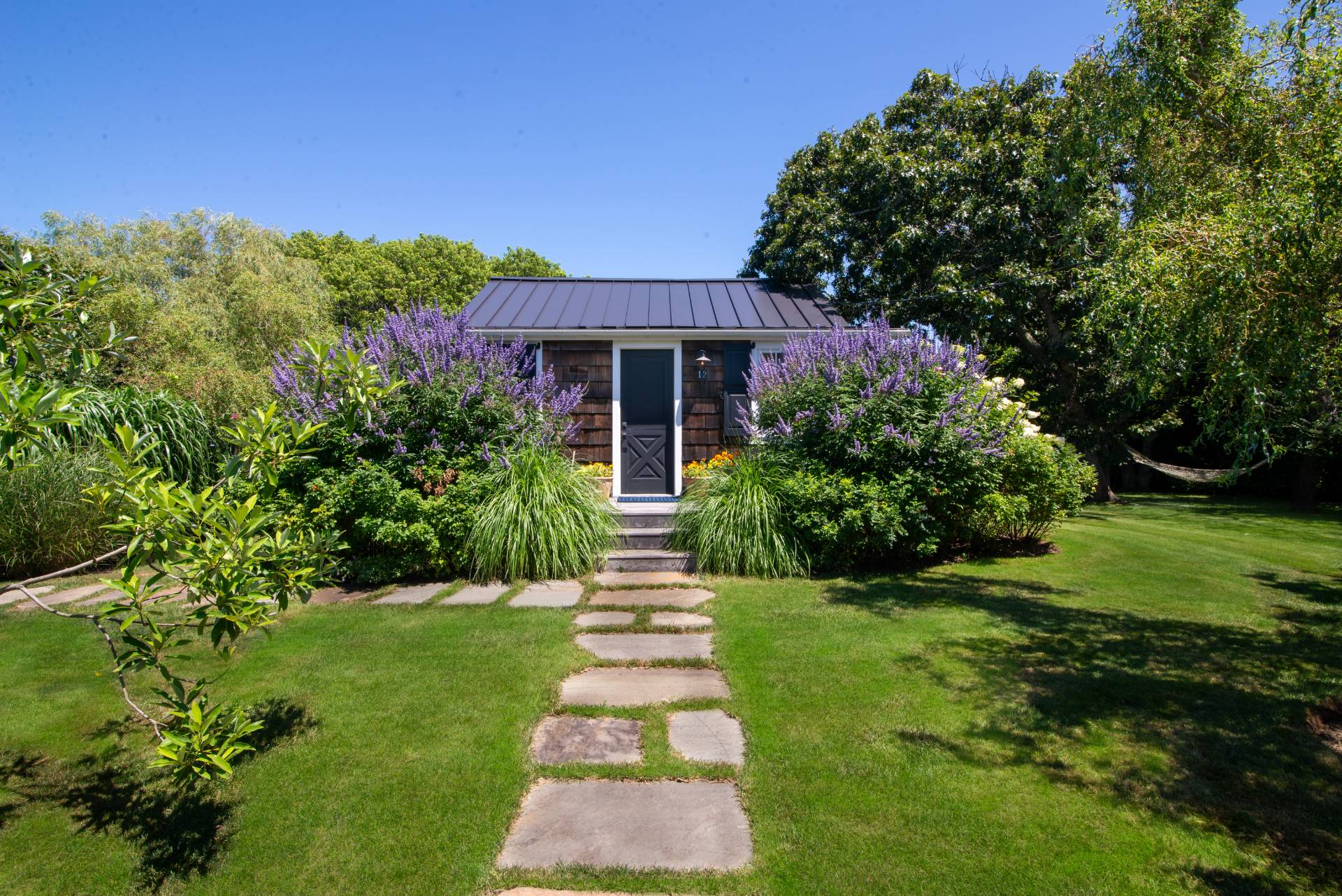 12 Jackson Road Montauk, NY 11954 - Photo 4 of 38 a front view of a house with a yard