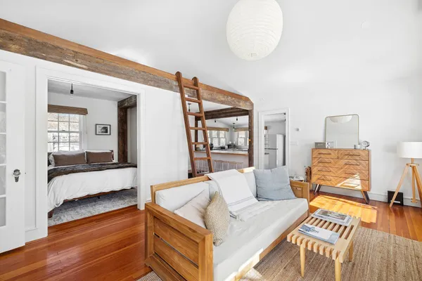 a living room with furniture and a wooden floor