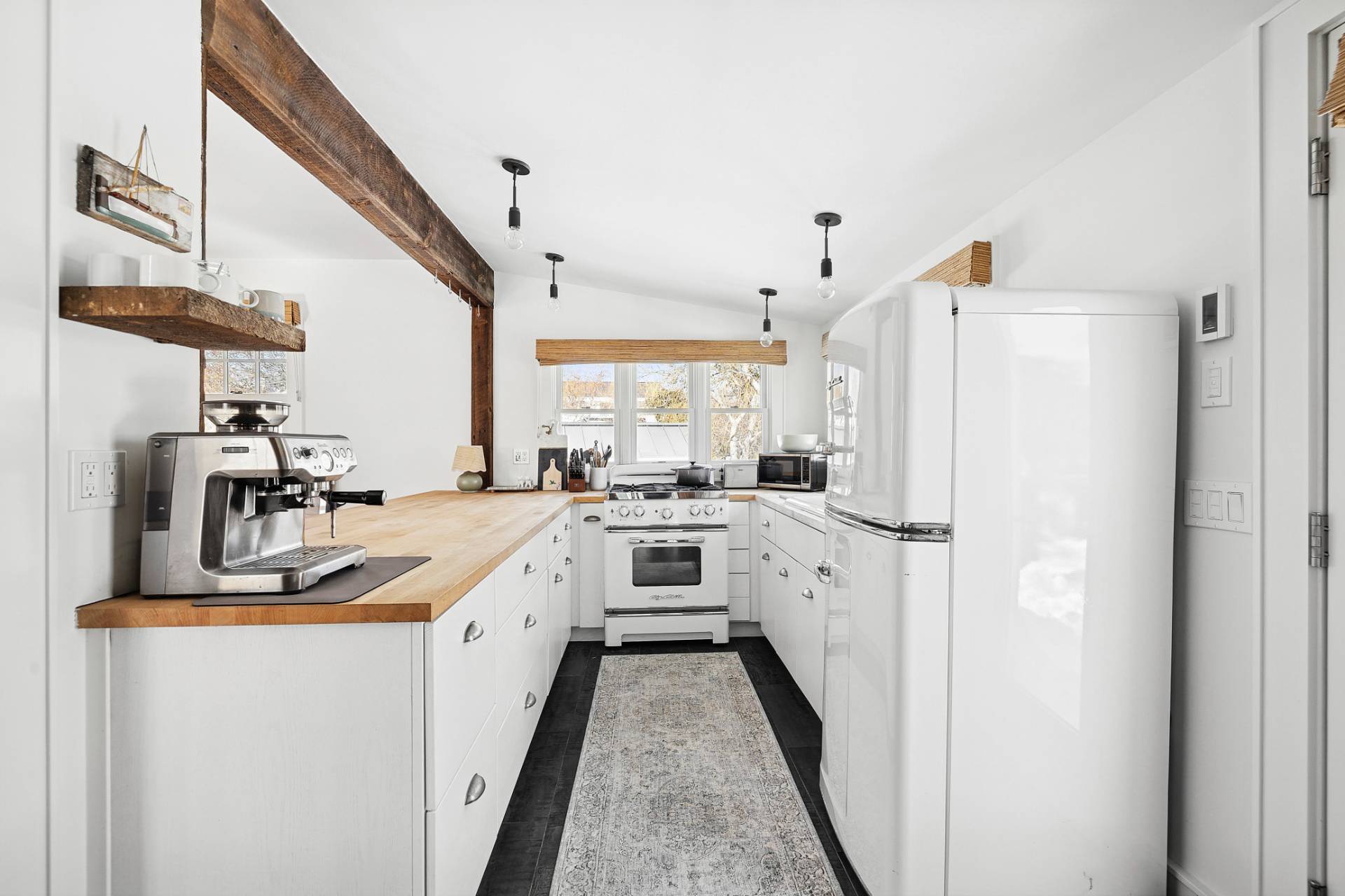 12 Jackson Road Montauk, NY 11954 - Photo 9 of 38 a kitchen with white cabinets and white appliances