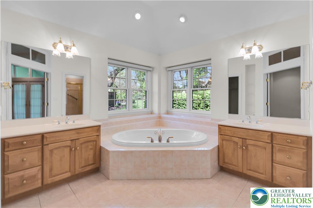 268 Jefferson Place Bethlehem, PA 18020 - Photo 25 of 49 a spacious bathroom with a tub a double vanity sink and a large mirror