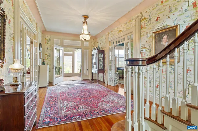 a living room with furniture fireplace and a large window