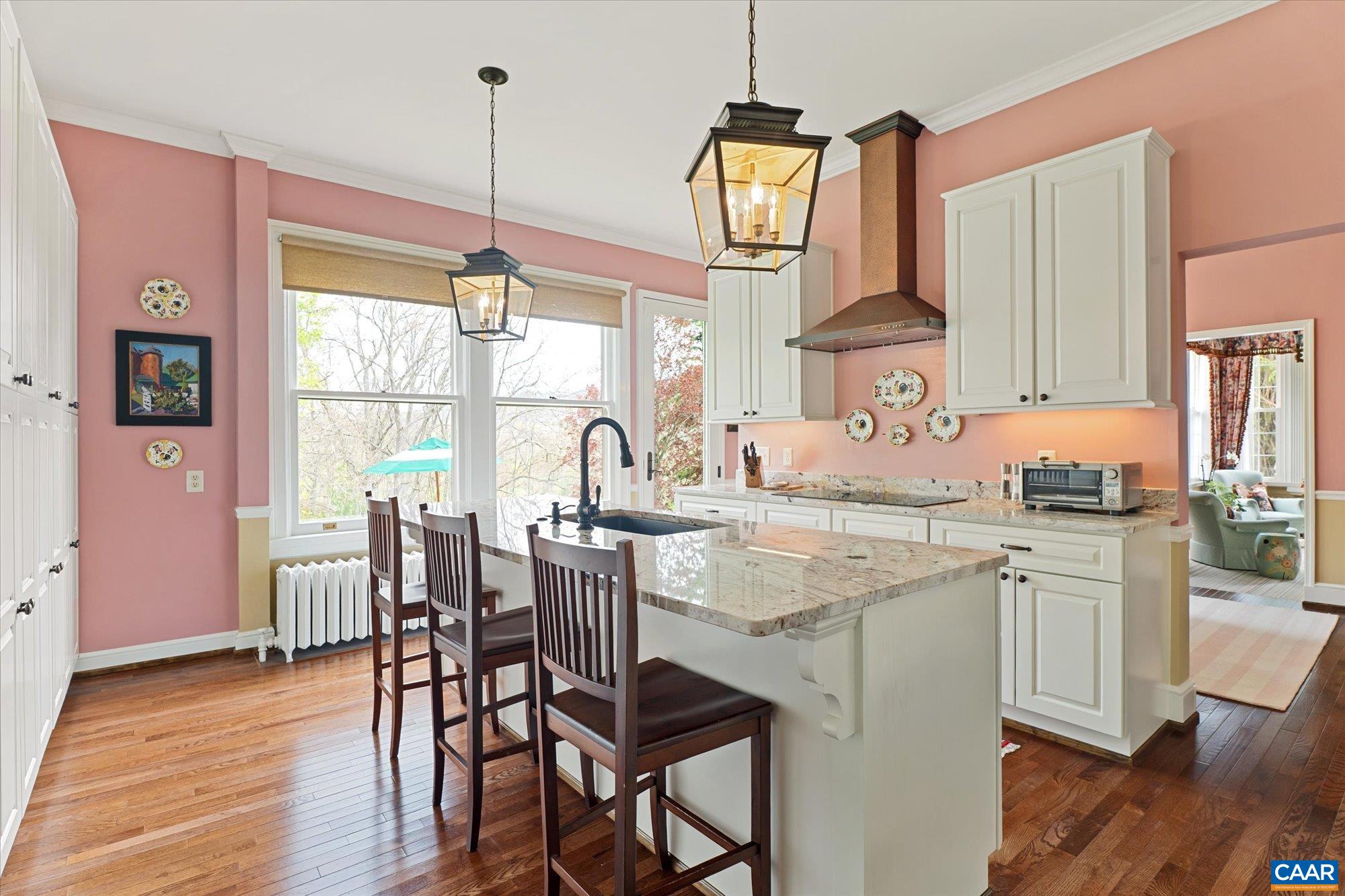 356 Routier Hill Road Hot Springs, VA 24445 - Photo 36 of 75 a kitchen with stainless steel appliances granite countertop wooden floor dining table and chairs