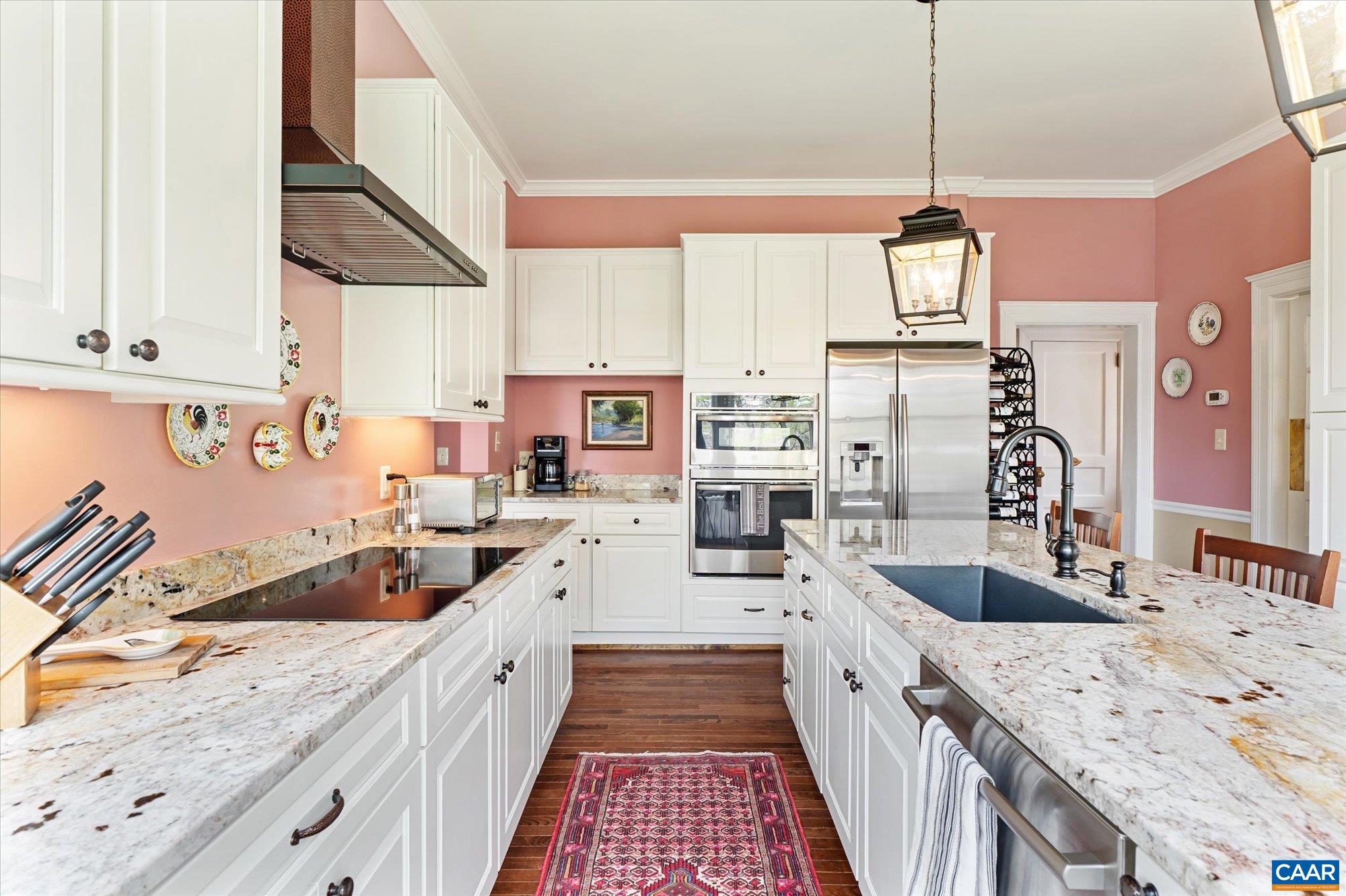 356 Routier Hill Road Hot Springs, VA 24445 - Photo 37 of 75 a large kitchen with stainless steel appliances kitchen island granite countertop a sink and cabinets