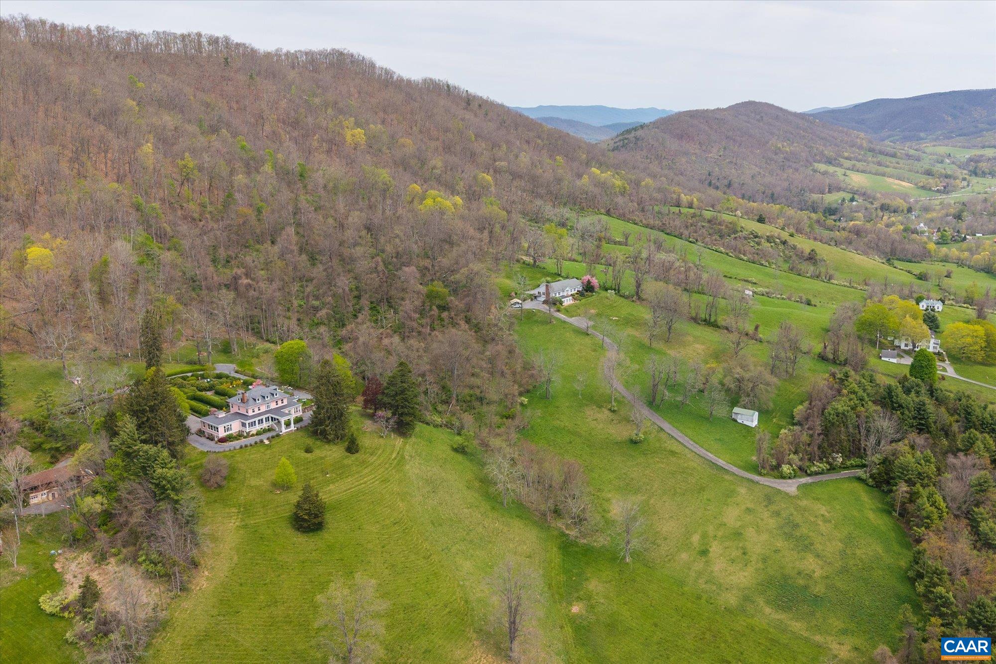 356 Routier Hill Road Hot Springs, VA 24445 - Photo 4 of 75 a view of a lush green hillside and a houses
