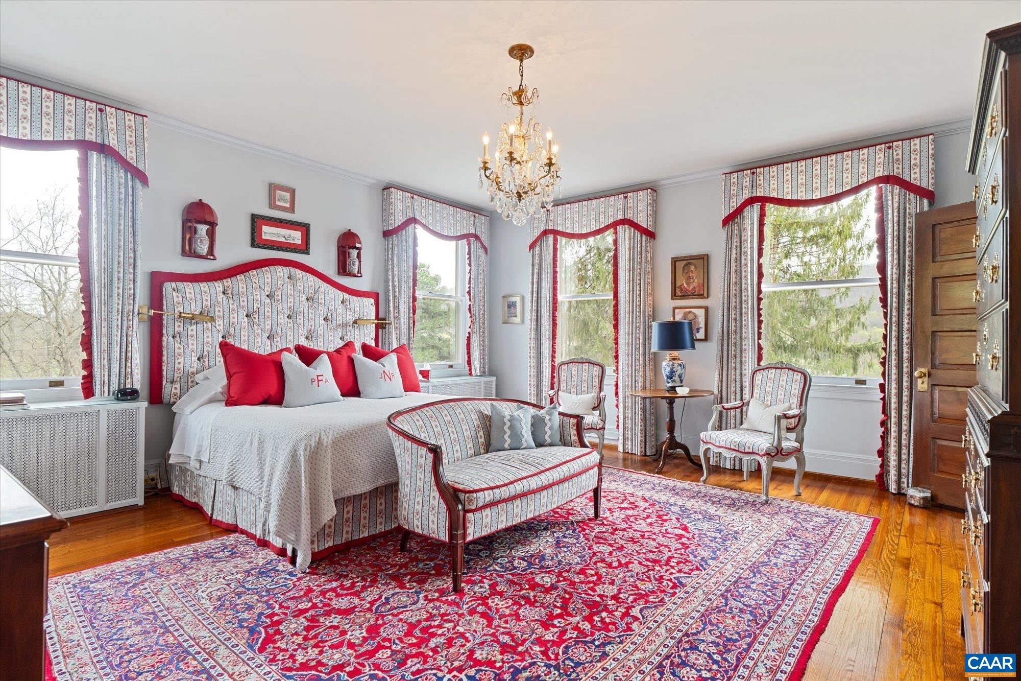 356 Routier Hill Road Hot Springs, VA 24445 - Photo 44 of 75 a bedroom with a bed and a chandelier