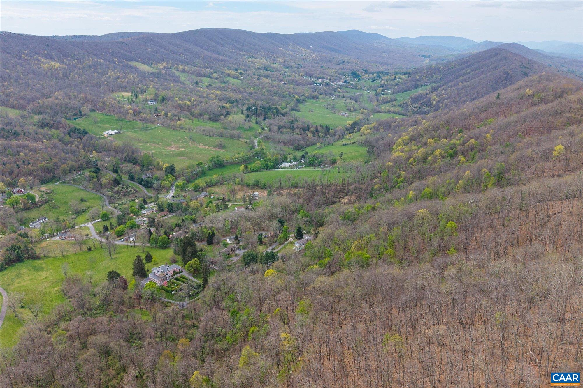 356 Routier Hill Road Hot Springs, VA 24445 - Photo 72 of 75 a view of a lush green hillside and a building