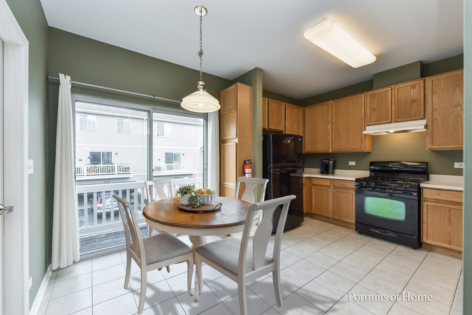 3464 Ravinia Circle Aurora, IL 60504 - Photo 8 of 22 a kitchen with stainless steel appliances granite countertop a stove a refrigerator a kitchen island a stove a dining table and chairs cabinets