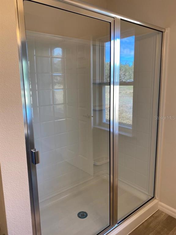 3331 Southwest 153rd Pl Road Ocala, FL 34473 - Photo 18 of 35 a bathroom with a glass shower door