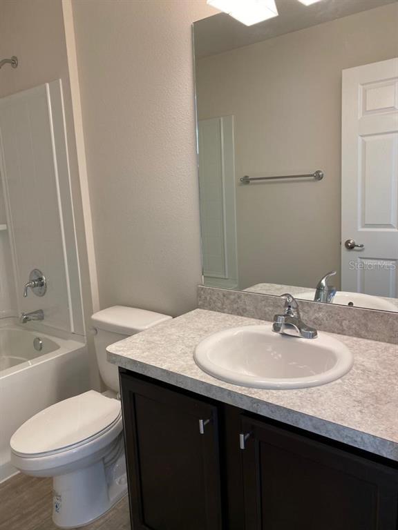3331 Southwest 153rd Pl Road Ocala, FL 34473 - Photo 21 of 35 a bathroom with a granite countertop sink toilet and shower