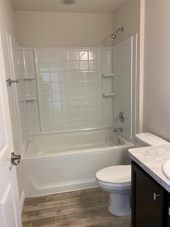 3331 Southwest 153rd Pl Road Ocala, FL 34473 - Photo 22 of 35 a bathroom with a granite countertop bathtub shower sink vanity and toilet