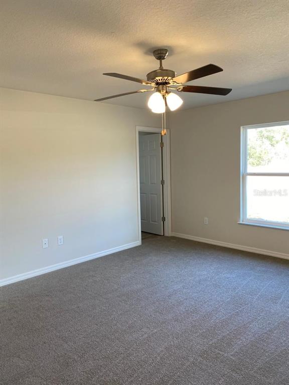 3331 Southwest 153rd Pl Road Ocala, FL 34473 - Photo 24 of 35 an empty room with a window and a fan
