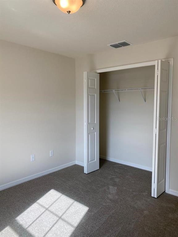 3331 Southwest 153rd Pl Road Ocala, FL 34473 - Photo 27 of 35 an empty room with a bench and cabinet