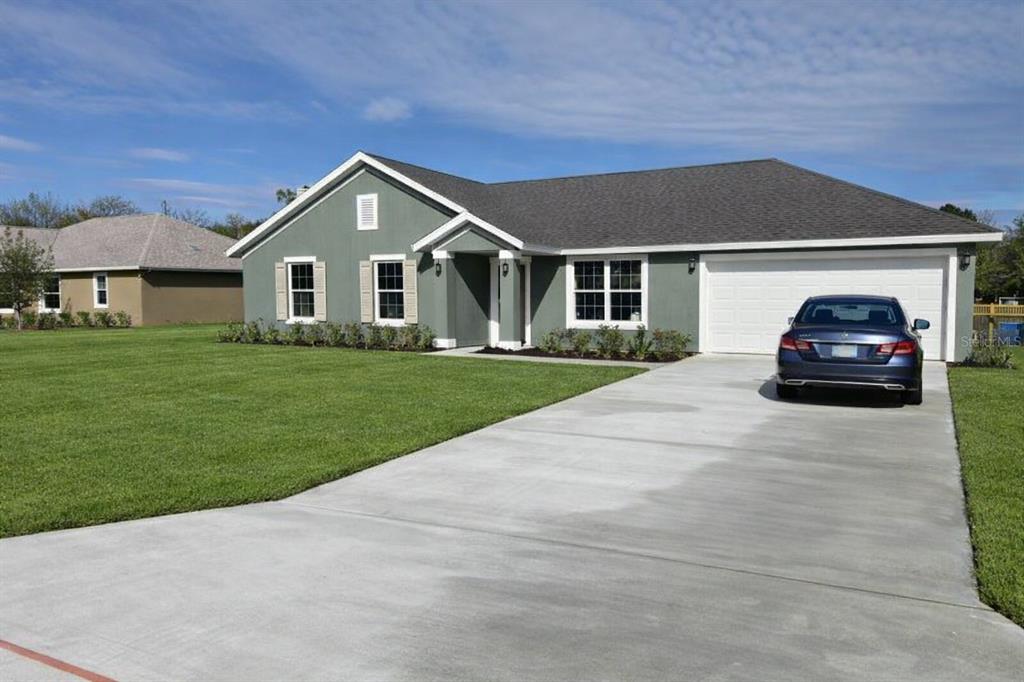 3331 Southwest 153rd Pl Road Ocala, FL 34473 - Photo 35 of 35 a house with huge green field in front of it