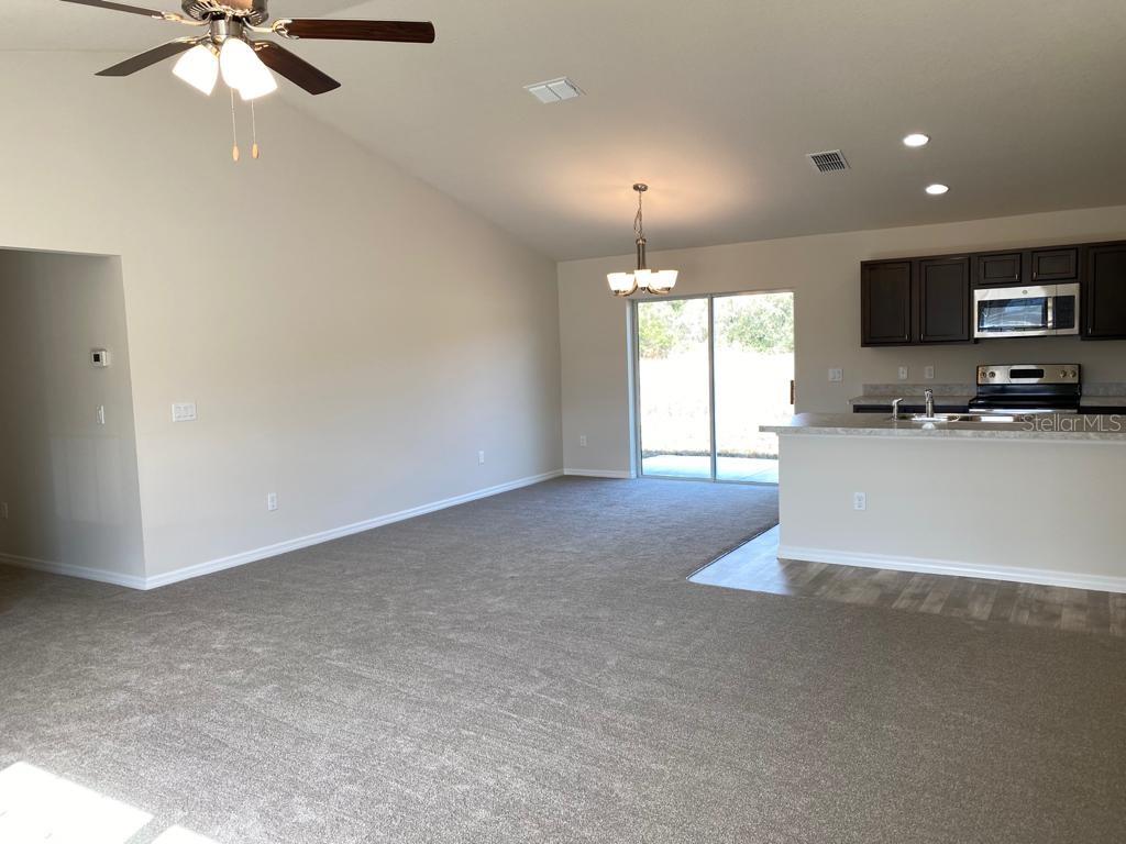 3331 Southwest 153rd Pl Road Ocala, FL 34473 - Photo 6 of 35 a large kitchen with cabinets a sink and a fireplace