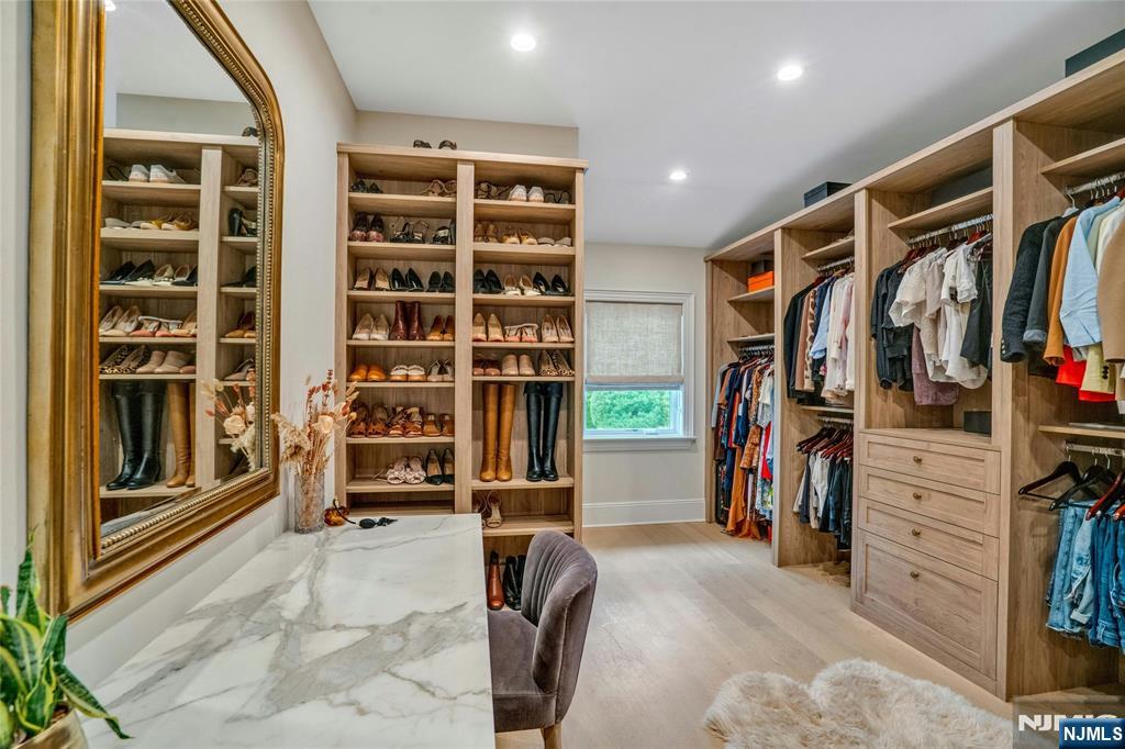 96 Bluff Road Fort Lee, NJ 07024 - Photo 16 of 22 a view of walk in closet with clothes and shoes