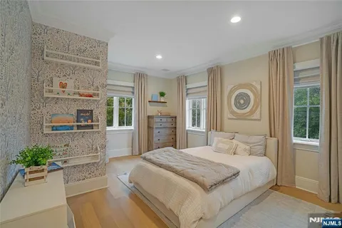 a spacious bedroom with a bed and a window