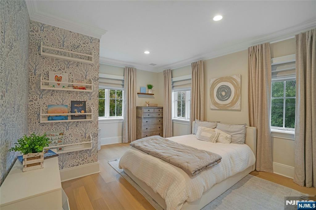 96 Bluff Road Fort Lee, NJ 07024 - Photo 17 of 22 a spacious bedroom with a bed and a window
