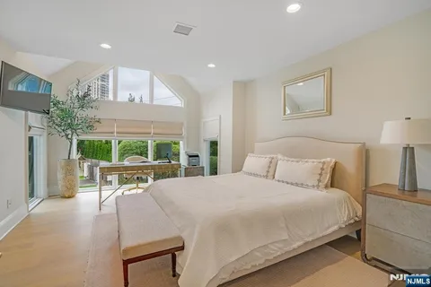 a bed room with a bed and a chair